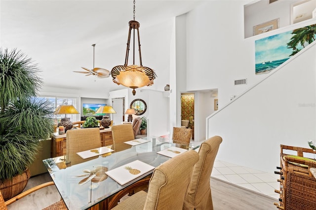 12130 Siesta Dr, Fort Myers Beach, FL 33931 - dining space with light tile patterned floors, a high ceiling, and visible vents