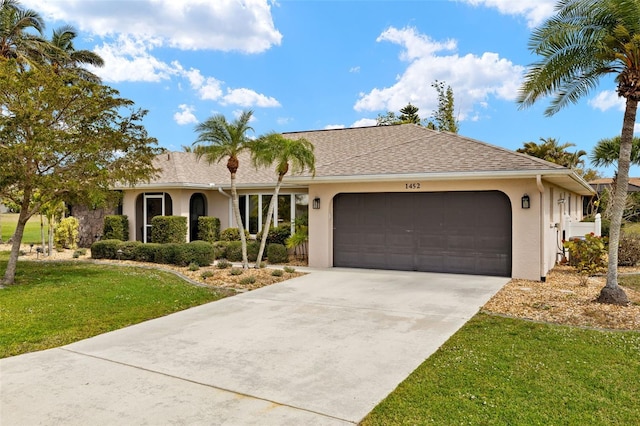 ranch-style home featuring an attached garage, driveway, roof with shingles, stucco siding, and a front lawn