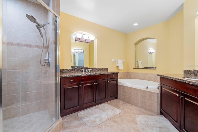 85 Vivante Blvd Unit 8542, Punta Gorda, FL 33950 - bathroom featuring a stall shower, two vanities, a bath, and tile patterned floors