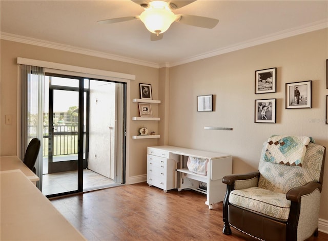 sitting room featuring baseboards, ceiling fan, ornamental molding, and wood finished floors