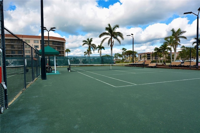 view of tennis court featuring fence