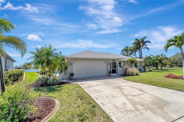 ranch-style home with stucco siding, an attached garage, concrete driveway, and a front yard