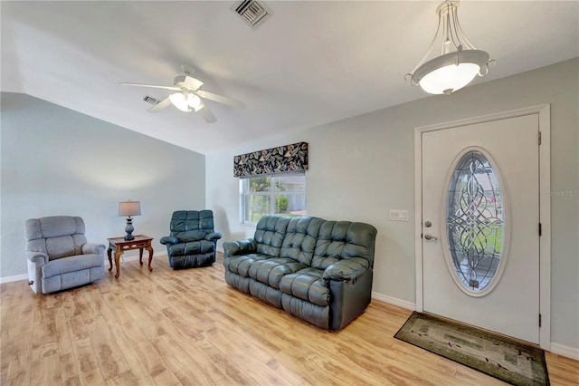 living area with baseboards, visible vents, light wood finished floors, and ceiling fan