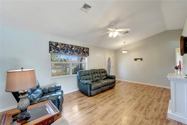 living room with visible vents, light wood-style flooring, a ceiling fan, and vaulted ceiling