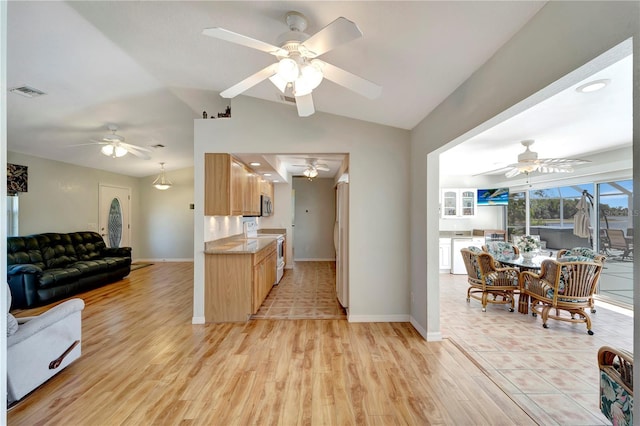 kitchen featuring visible vents, ceiling fan, open floor plan, lofted ceiling, and white appliances