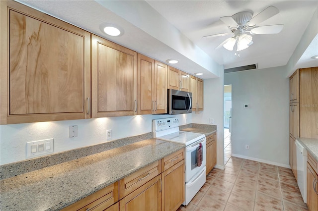 kitchen with stainless steel microwave, baseboards, ceiling fan, light stone countertops, and electric stove