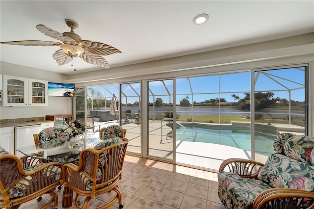 sunroom / solarium with a swimming pool and ceiling fan