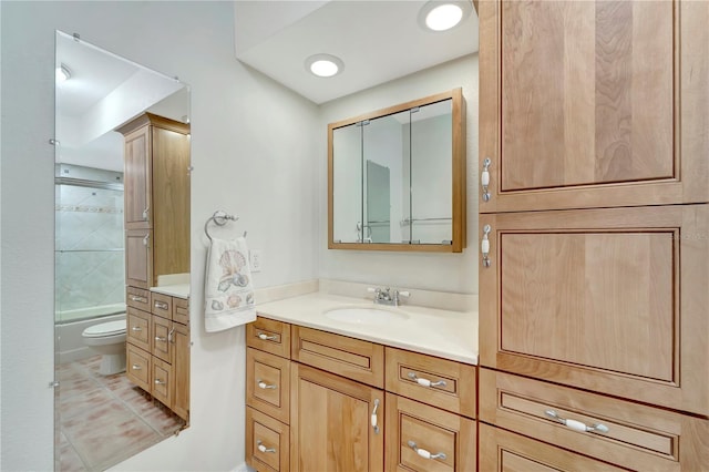 full bathroom featuring tile patterned flooring, bath / shower combo with glass door, vanity, and toilet