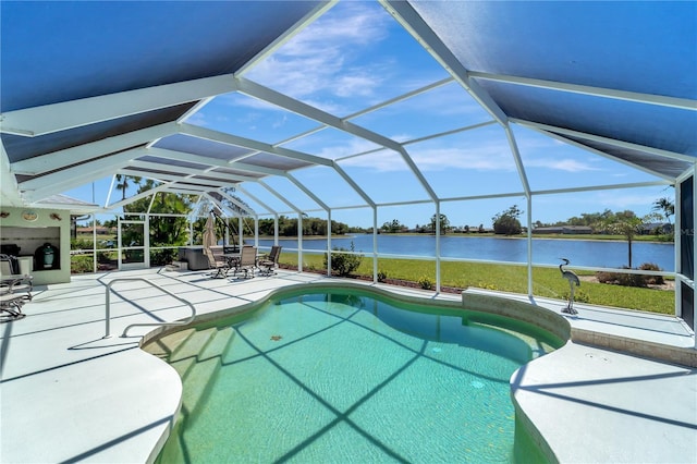 pool featuring glass enclosure, a patio, and a water view