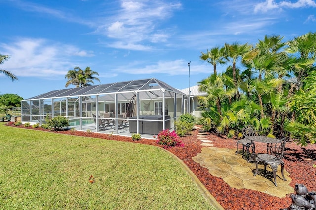 view of yard featuring an outdoor pool, glass enclosure, and a patio