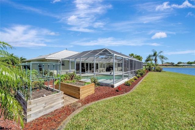 rear view of property with a water view, a lawn, a vegetable garden, an outdoor pool, and a lanai