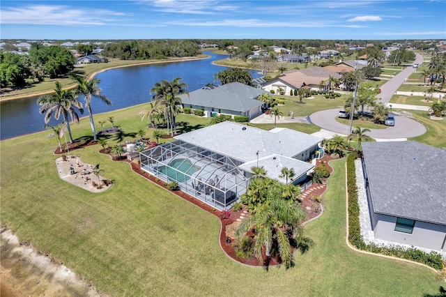 drone / aerial view featuring a residential view and a water view