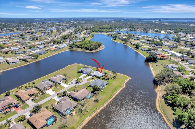 drone / aerial view featuring a residential view and a water view