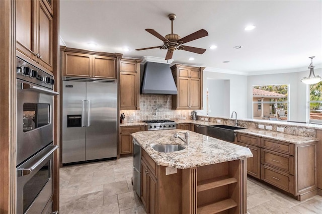 kitchen featuring a sink, tasteful backsplash, premium range hood, and stainless steel appliances