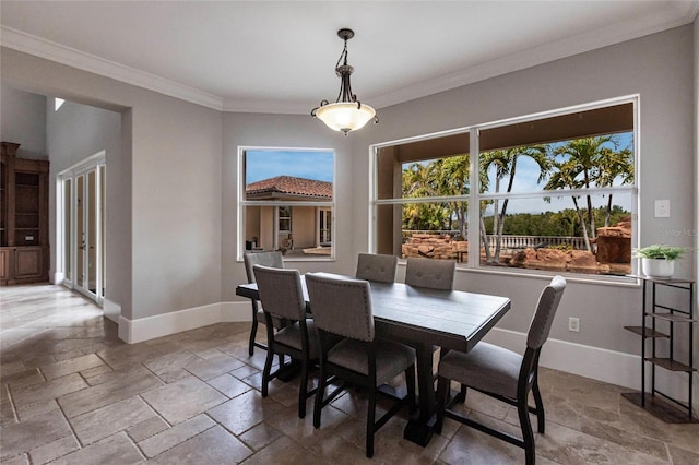 dining area with stone tile floors, baseboards, and ornamental molding