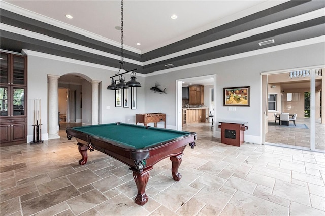 playroom with stone tile floors, baseboards, ornate columns, arched walkways, and ornamental molding