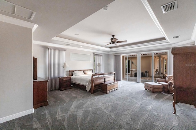 carpeted bedroom featuring a tray ceiling, baseboards, visible vents, and ceiling fan