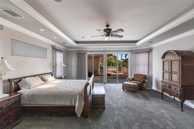 carpeted bedroom with visible vents, crown molding, baseboards, a tray ceiling, and access to outside