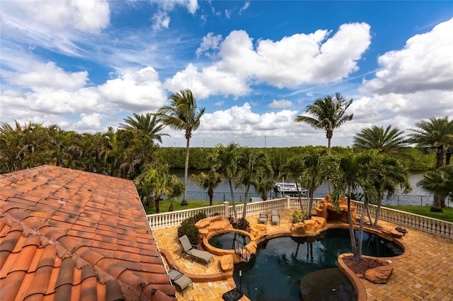 view of swimming pool featuring an in ground hot tub and a water view