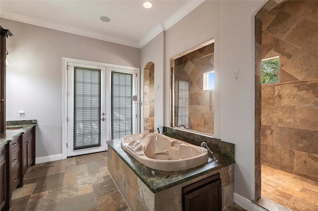 full bathroom with stone tile floors, a tub with jets, baseboards, a walk in shower, and crown molding