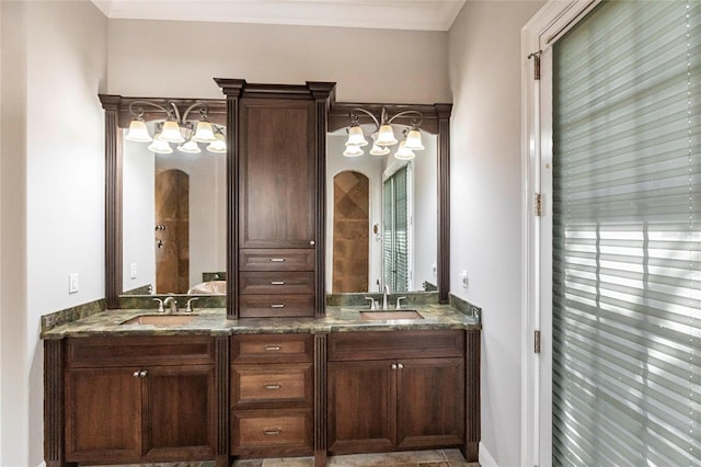 full bathroom featuring double vanity, crown molding, a wealth of natural light, and a sink