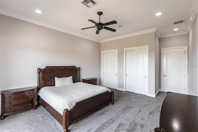 bedroom with carpet, baseboards, visible vents, and multiple closets