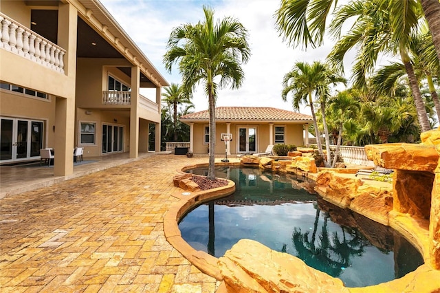 view of swimming pool featuring a patio area and french doors