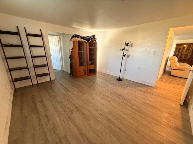 interior space with baseboards and wood finished floors