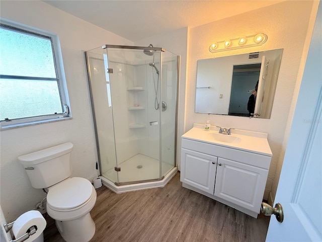 full bath featuring toilet, a shower stall, vanity, and wood finished floors