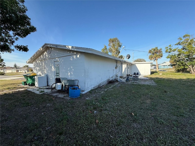 view of property exterior with a yard