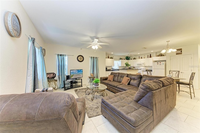 315 Southland Rd, Venice, FL 34293 - living area with light tile patterned floors and ceiling fan with notable chandelier