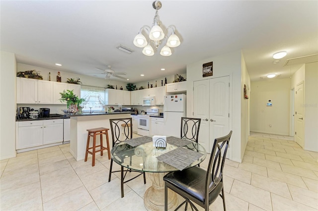 315 Southland Rd, Venice, FL 34293 - dining area with attic access, ceiling fan with notable chandelier, visible vents, and light tile patterned floors