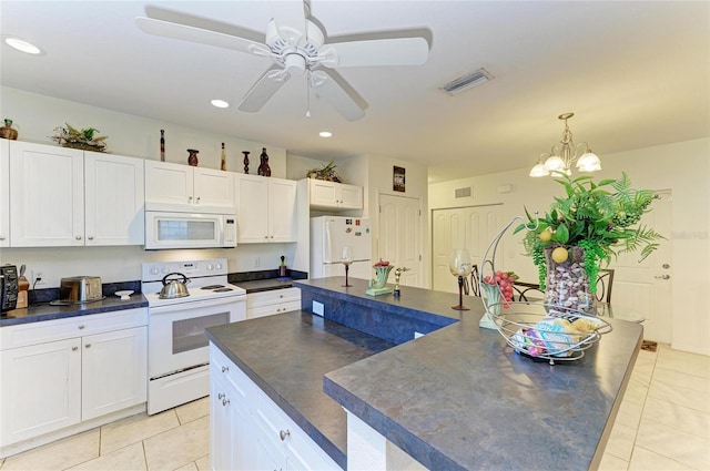 315 Southland Rd, Venice, FL 34293 - kitchen featuring white appliances, dark countertops, and white cabinets