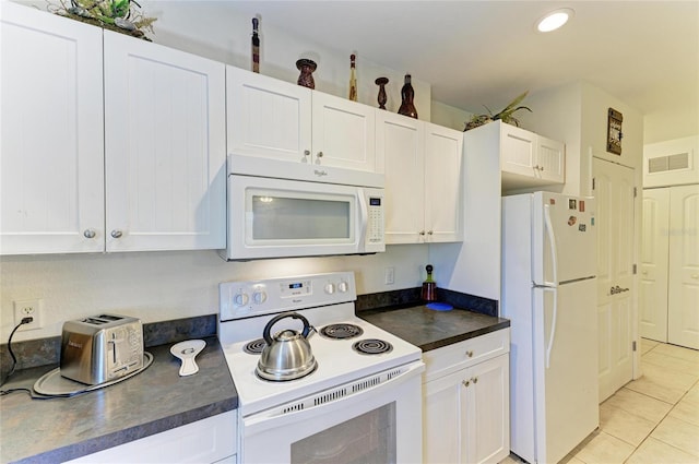 315 Southland Rd, Venice, FL 34293 - kitchen featuring dark countertops, white appliances, visible vents, and white cabinets
