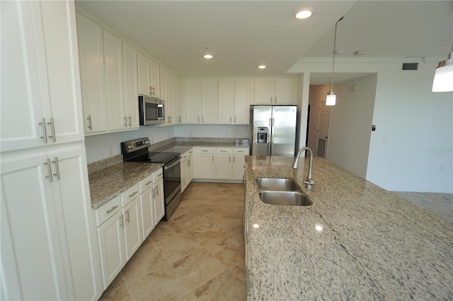 kitchen featuring light stone counters, appliances with stainless steel finishes, and white cabinetry