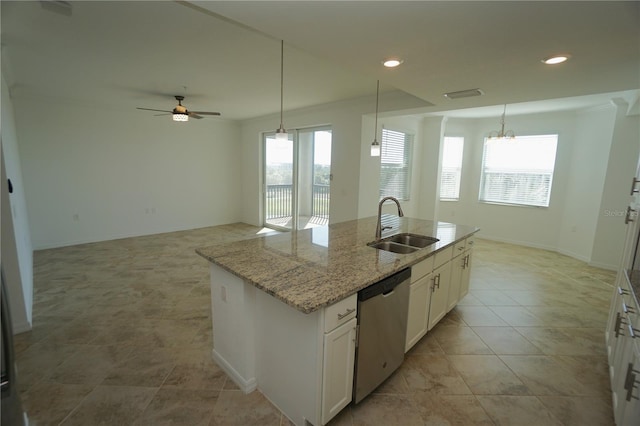 kitchen featuring a center island with sink, dishwasher, open floor plan, decorative light fixtures, and white cabinetry