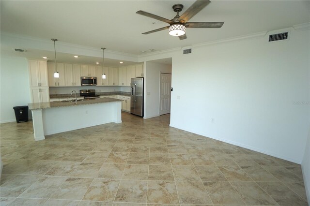 kitchen with a kitchen island with sink, visible vents, white cabinetry, appliances with stainless steel finishes, and decorative light fixtures