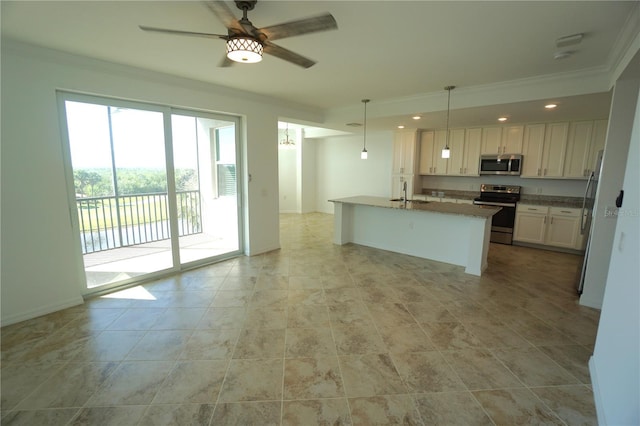 kitchen with white cabinets, ornamental molding, decorative light fixtures, a kitchen island with sink, and stainless steel appliances