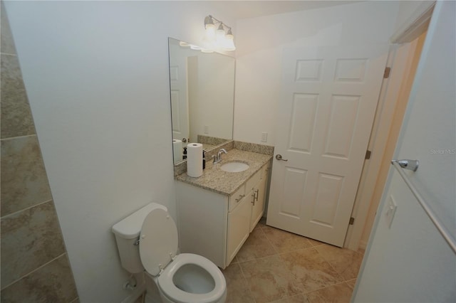 half bathroom with toilet, tile patterned flooring, and vanity