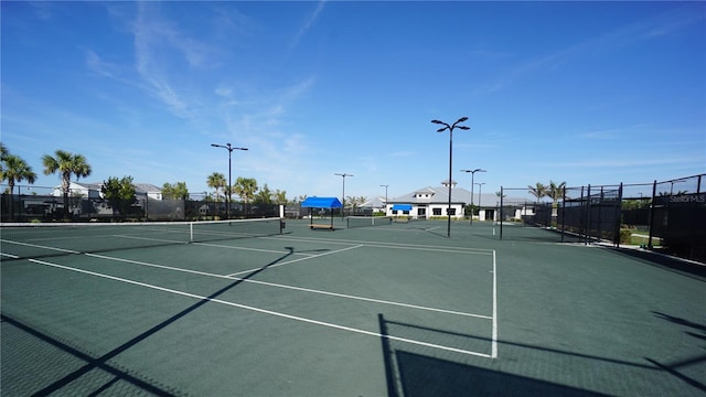 view of tennis court with fence