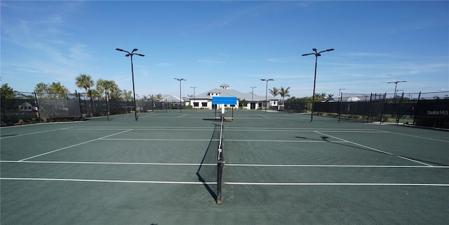 view of tennis court featuring fence