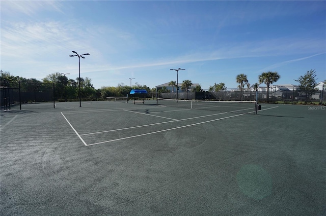 view of sport court featuring fence