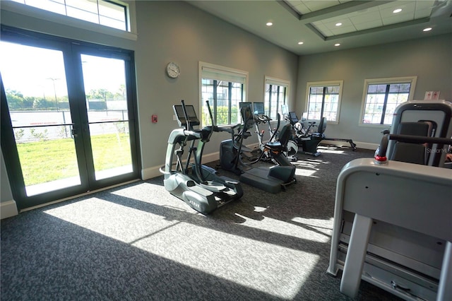 exercise room with recessed lighting, french doors, a healthy amount of sunlight, and baseboards