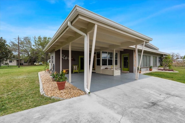 exterior space featuring driveway and a front yard