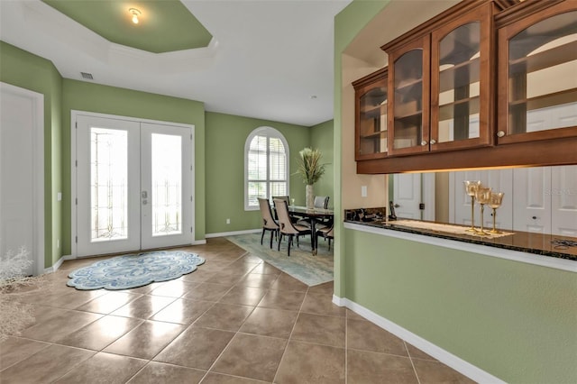 entryway with baseboards, french doors, visible vents, and tile patterned floors