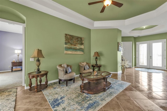 living area featuring tile patterned flooring, french doors, baseboards, and a tray ceiling