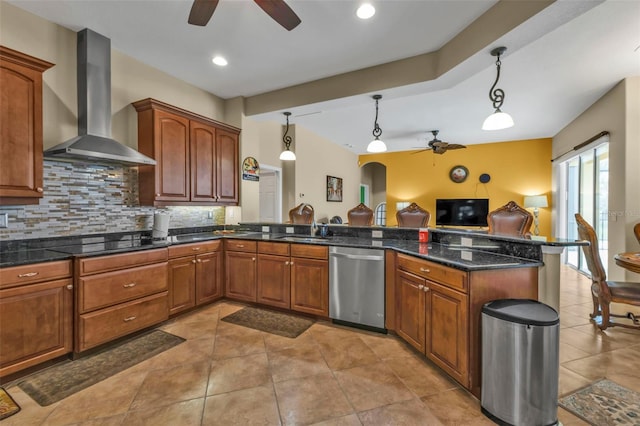 kitchen with black electric cooktop, a peninsula, wall chimney range hood, stainless steel dishwasher, and backsplash