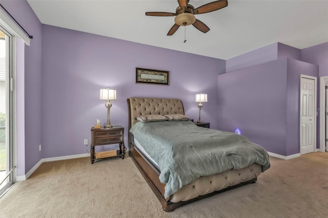 carpeted bedroom with ceiling fan and baseboards