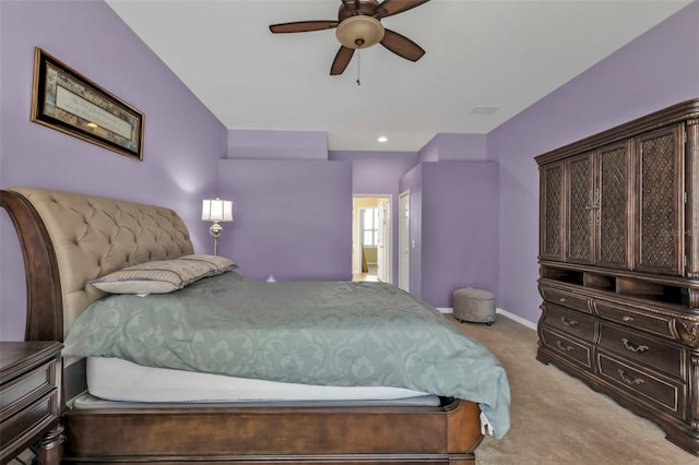 bedroom with light colored carpet, ceiling fan, and baseboards