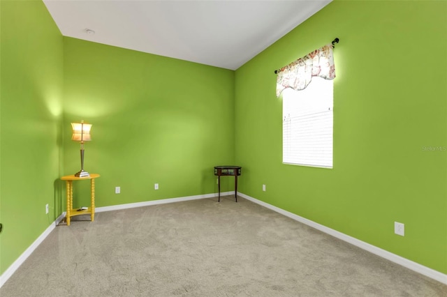 carpeted spare room with baseboards